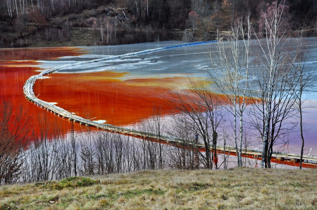 Natural disaster. Pollution of a lake with contaminated water from a gold mine
